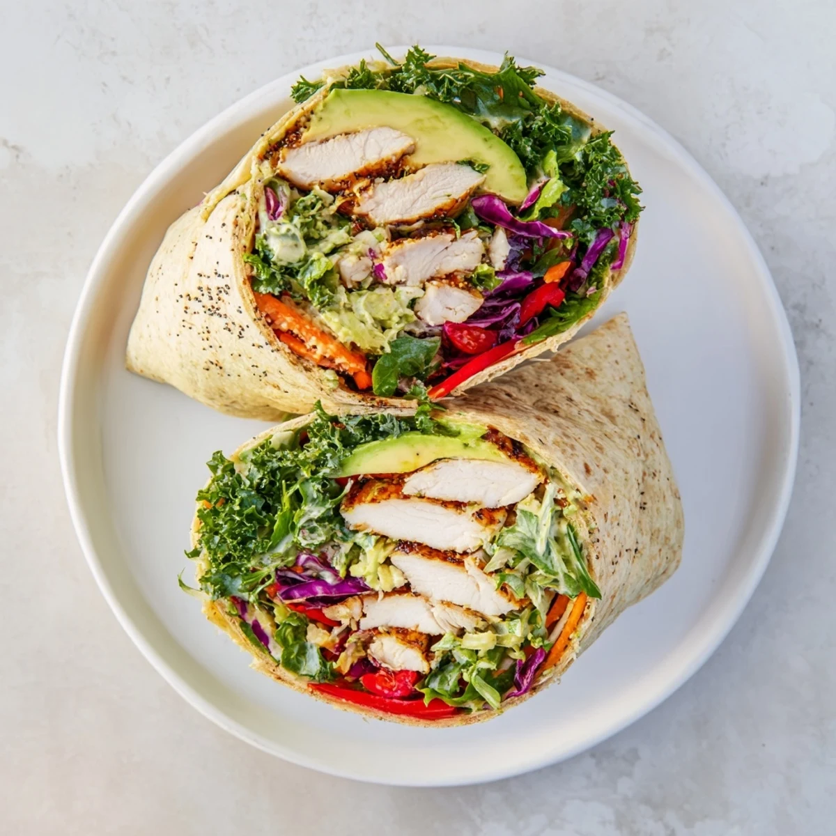 Brightly colored Poppy-Inspired Chicken Salad Wraps, filled with tender chicken and poppy seed dressing, ready to enjoy.
