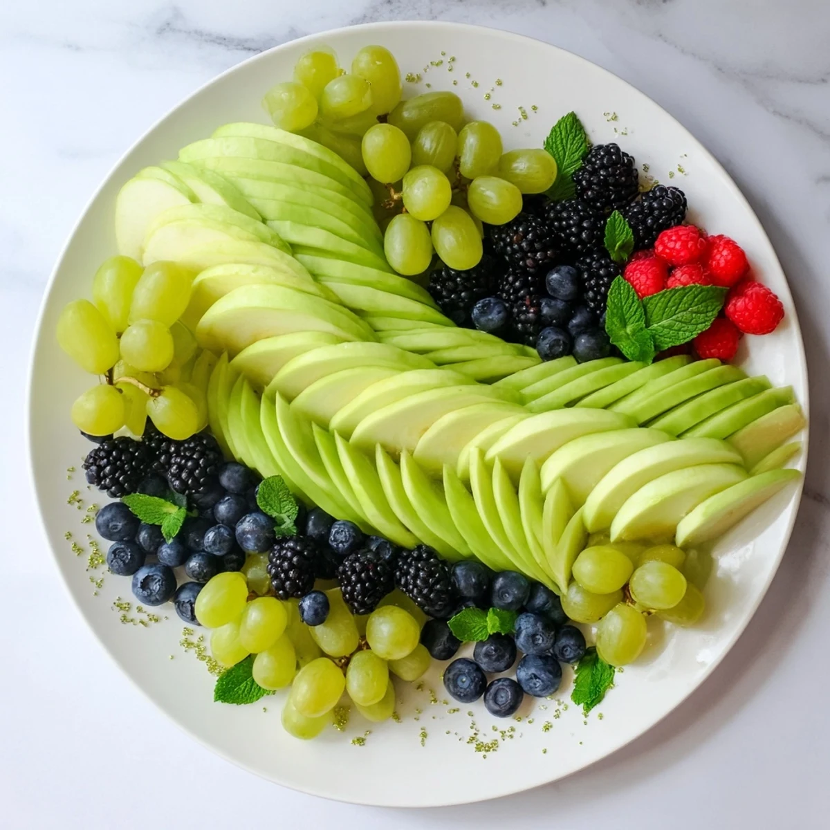 A colorful Aurora Borealis Sweep, showcasing a vibrant fruit platter with fresh green and purple fruits.