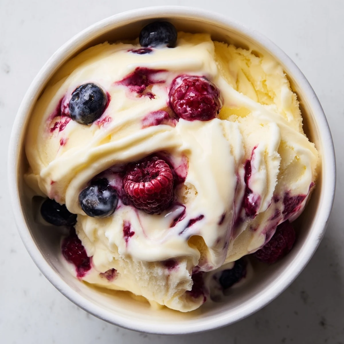 A vibrant photo displays creamy cottage cheese ice cream, swirled with berry goodness for a refreshing dessert.