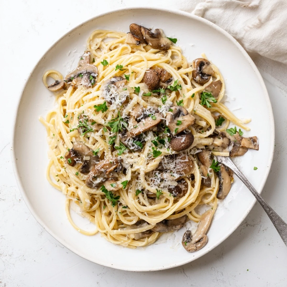 Steaming bowl of Creamy Mushroom Linguine, with tender mushrooms and fresh parsley garnish, ready for a weeknight dinner.
