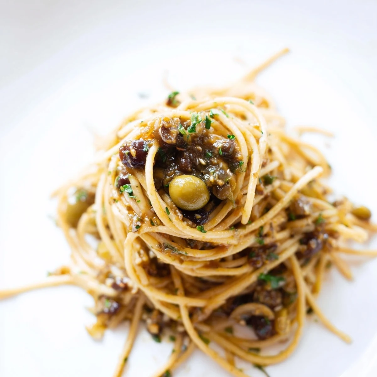 Fork-tender Olive Tapenade Pasta tossed with a briny olive and caper sauce, finished with fresh lemon zest and parsley.