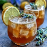 Refreshing lavender lemonade spritz with sparkling wine, garnished with fresh lemon slices and lavender sprigs.