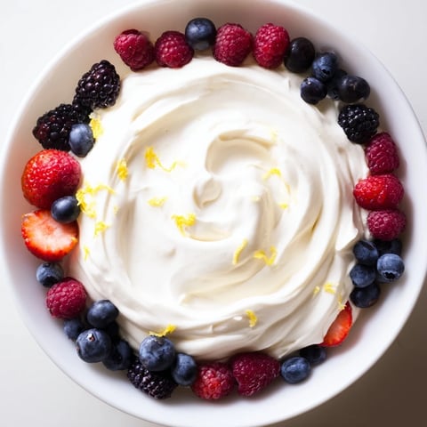 Fluffy cream cheese fruit dip with fresh, vibrant berries ready for easy snacking pleasure.