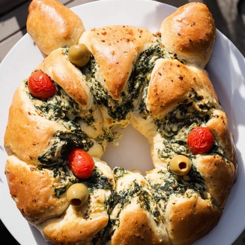 A beautifully decorated Reindeer Antler Spinach Dip Ring, with creamy spinach oozing from pull-apart bread.