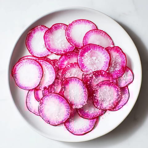 Fresh, crunchy radish slices lightly seasoned, a simple and elegant appetizer.