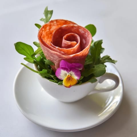 Savor the visual of delicate salami and pepperoni folded into a Victorian Tea Rose with fresh garnishes.