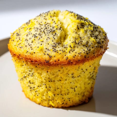 Fluffy Lemon Poppy Seed Muffins with a tangy lemon glaze, perfect morning baked goods and delightful snack.