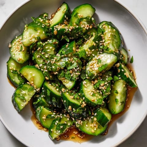 Vibrant Zesty Shake Cucumber Salad, a vegan delight with fresh cilantro and crunchy cucumber slices.