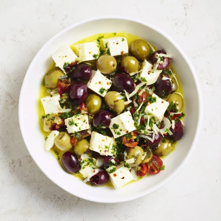 Freshly marinated Holiday Mix shows a colorful appetizer of olives and feta, perfect for a party.