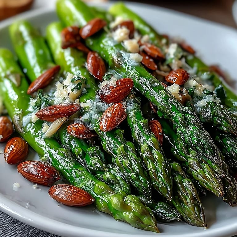 Tender asparagus sautéed in zesty lemon butter and garnished with crunchy almonds, perfect for Easter or Mother's Day.