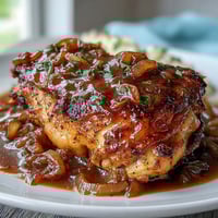 Juicy chicken thighs and drumsticks smothered in savory onion gravy, a comforting Southern soul food classic.
